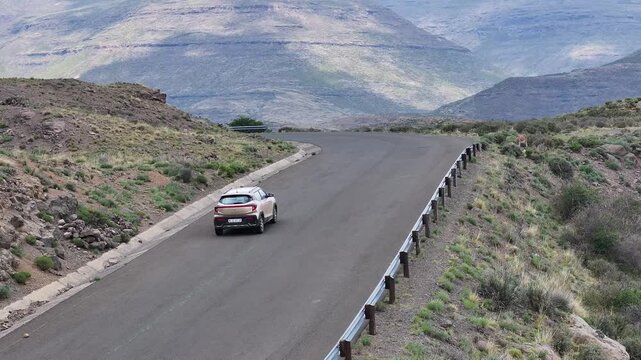 Aerial view of car driving along epic mountain roads in Lesotho, Africa