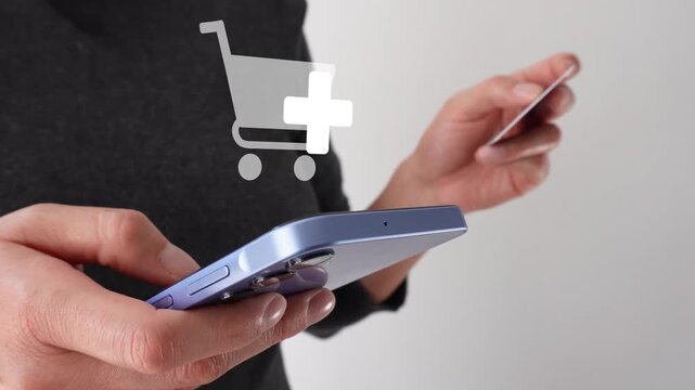 Businesswoman holding a bank card while holding a smartphone. An animation of the shopping icon with the add-on button. Add more products to your cart.