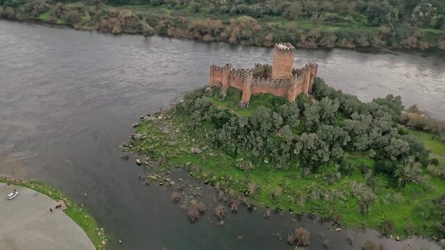 Majestic Almourol Castle on a lush island surrounded by tranquil river