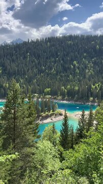 Caumasee Switzerland alpine Lake Cauma in Flims turquoise color water, aerial drone vertical video