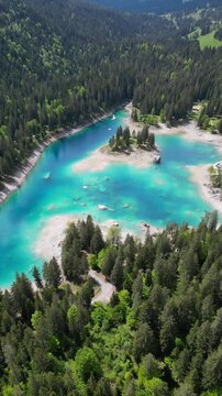 Lake Cauma Caumasee Switzerland alpine in Flims turquoise color water, aerial drone vertical video