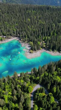 Aerial vertical video Caumasee Lake Cauma in Flims, Switzerland turquoise color water