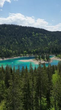 Switzerland alpine Lake Cauma Caumasee in Flims turquoise color water, aerial drone vertical video