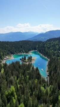 Caumasee Lake Cauma in Flims, Switzerland turquoise color water, aerial vertical video