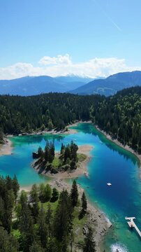 Lake Cauma Caumasee in Flims, Switzerland turquoise color water, aerial vertical video