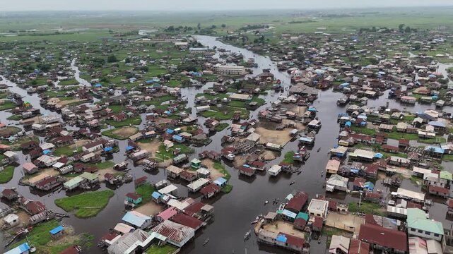 Drone shot revealing the dense urban-like structure of the Ganvie water settlement in Benin, surrounded by the reflective surface of Lake Nokoue Africa Aerial footage