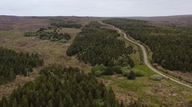 Drone shot of a peatland dirt track winding uphill on the Isle of Lewis.