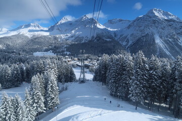 Gorgeous view of snowy Swiss alps and trees in Arosa, Switzerland