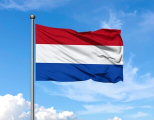 A national flag, with horizontal stripes, flutters against a bright blue sky