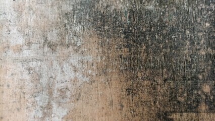 Obraz premium Worn Wooden Board Texture with Dark Stains and Scratches. Old wooden board surface with heavy stains, scratches, and natural aged texture