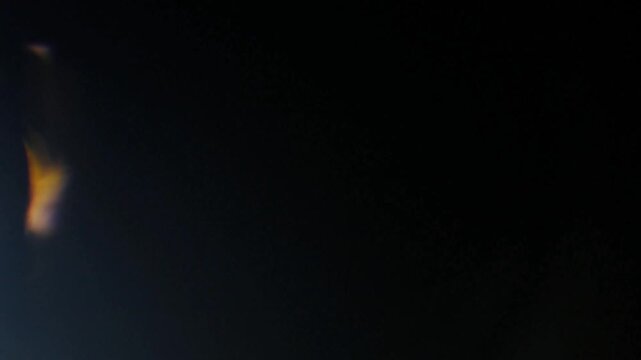 High-Resolution Moving Light Flares with Dramatic Black Backdrop, A showcasing a mesmerizing display of light trails in a dark environment