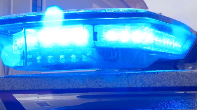 Blue police and gendarmerie beacon flashing emergency warning lights at daytime