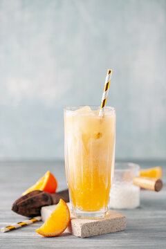 Homemade Cold Dirty Soda with  Coconut Cream, Ice and Orange. Alcohol free mocktail