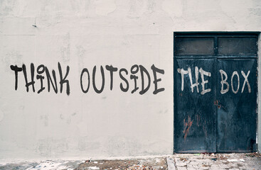 Think outside the box graffiti on a wall