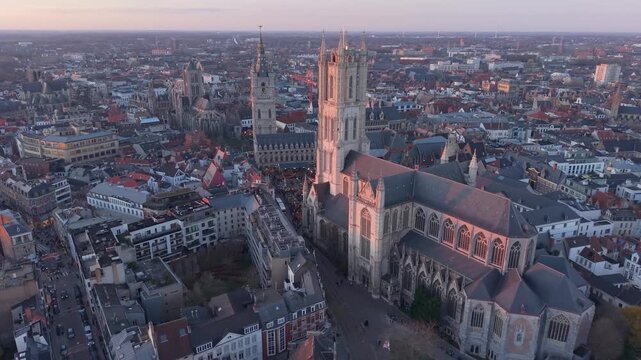 Warm afternoon light over the cityscape of Ghent, highlighting picturesque buildings and historic architecture in a calm and atmospheric urban scene.