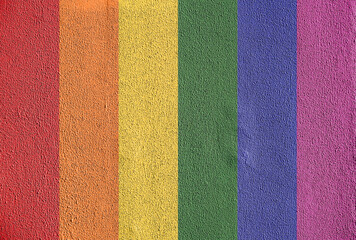 Rainbow pride colors painted rough textured wall
