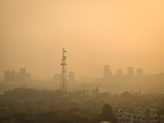 Fototapeta premium Heavy polluted atmosphere in the city, blurred sky dark with air pollution smoke cloud dust mist for background, problem in atmosphere. Low visibility and High air pollution. Toxic harmful air.
