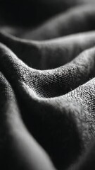 Dark fabric texture with dramatic lighting and shadows