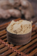 Ground ginger powder on wooden surface