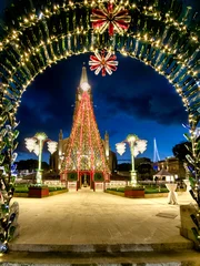 Ghajnsielem, Gozo, Malta - Beautiful, unusual Christmas decorations made from colorful and white bottles in front of the church in the evening. © EKH-Pictures