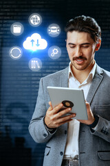 Businessman using tablet for cloud technology and data management in a modern office setup