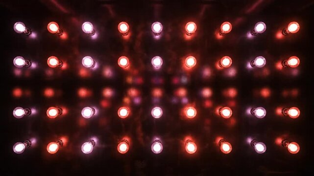 Abstract illuminated wall of bulbs changing colors for stage or studio background effects