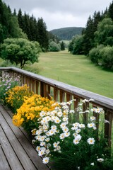 Obraz premium Flower boxes on wooden terrace overlooking green valley
