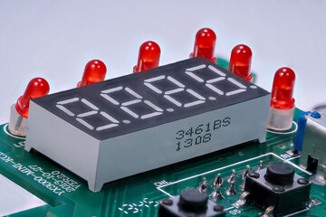 Detail of a turned off display with red LEDs on a printed circuit board.