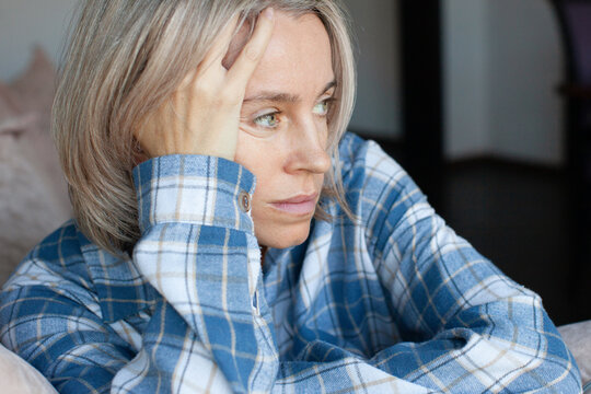 Close up portrait of joyless 40s woman alone indoor, female with sad eyes