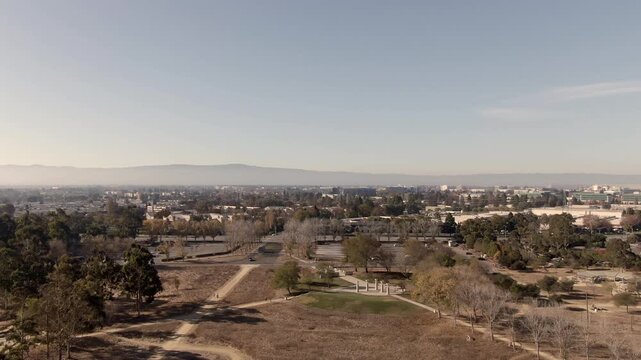 Wide-angle drone panorama of South San Jose, featuring tech company buildings, Highway 101, and the distant San Francisco Bay. A perfect cinematic establishing shot for Northern California.