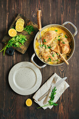 Creamy chicken thighs with mustard mushroom sauce and fresh garnish on rustic table