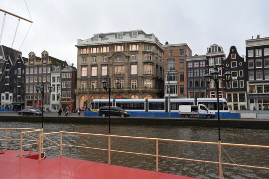 Panoramic view of Rokin canal in Amsterdam with trams, tour boats, and construction works during winter, Netherlands, January 2016 