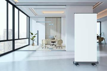 Blank roll-up mockup banner standing in modern corporate office hallway interior with glass walls and city view in background. 3D Rendering