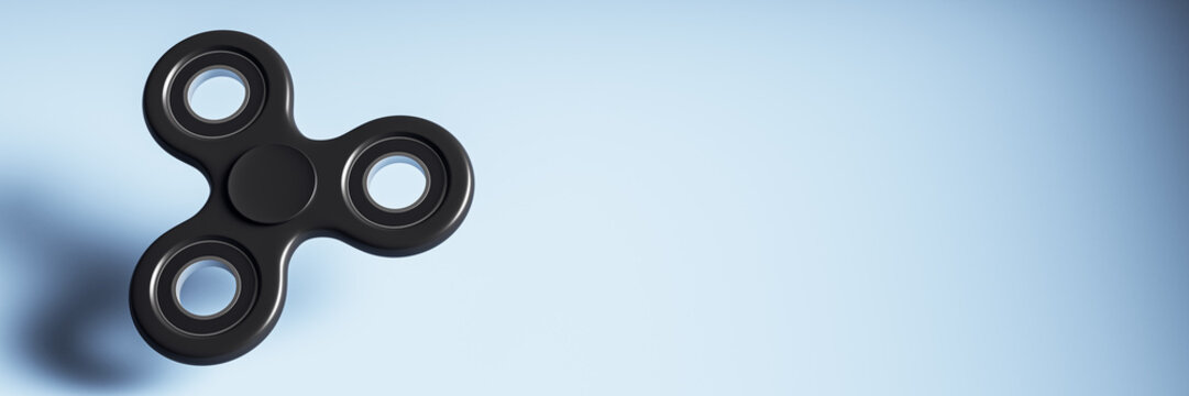 Black fidget spinner isolated on light gradient background with copy space for creative hobby design or contemporary product mockup template. 3D Rendering