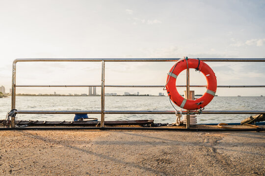 lifebuoy attached to pier handrail at harbor