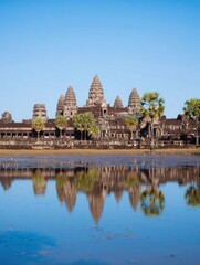 Ancient Stone Temple Complex Reflected in Still Water with Clear Blue Sky, Symmetrical Landmark Architecture at Heritage Site for Travel and Tourism Background
