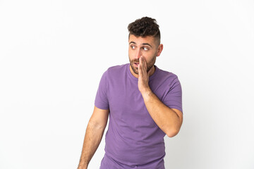 Fototapeta premium Caucasian man isolated on white background whispering something with surprise gesture while looking to the side