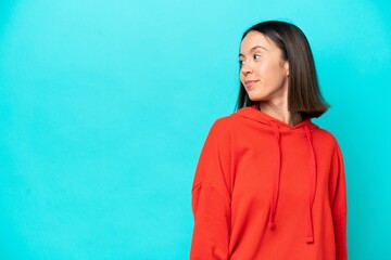 Fototapeta premium Young caucasian woman isolated on blue background . Portrait