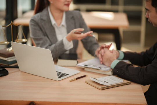 Professional Female Lawyer Consoling and Consulting Client in Law Office
