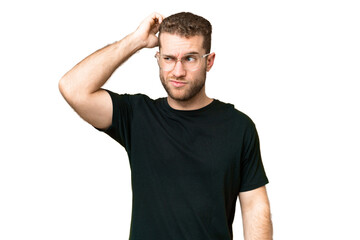 Obraz premium Young handsome blonde man over isolated chroma key background having doubts while scratching head