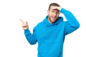 Fototapeta premium Young handsome blonde man over isolated chroma key background surprised and pointing finger to the side