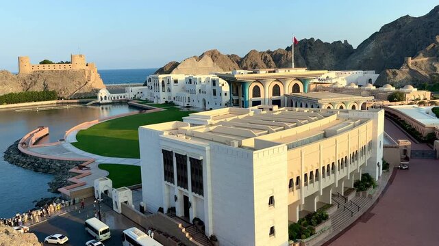View from Mutrah beach in Muscat showing Al Jalali Fort, Al Alam Palace and historic landmarks by the sea.