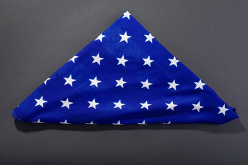 Obraz premium White stars on triangle shape folded america flag on black background with copy space
