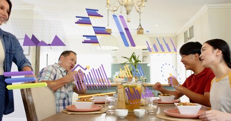 Sharing family wearing casual wear passing bowls, pouring juice at kitchen table, showing AR charts © vectorfusionart