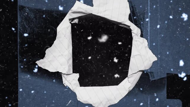 The video has a black and white theme, like torn paper, creating the effect of looking through a hole while snow and dust are flying.