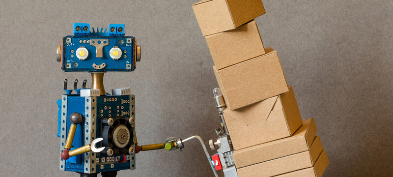 Delivery service, robotics storekeeper business. A courier robot holds a pushcart with parcels packed in boxes. the concept of automation of the service for the delivery of goods, orders shipments