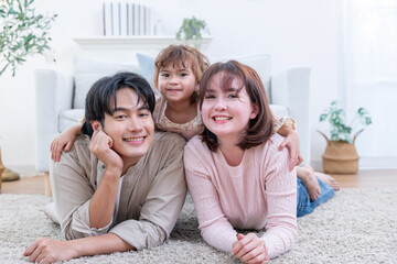 Asian family enjoys spending their time together in a living room
