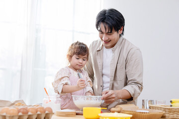 Family enjoys baking bakery together in the kitchen