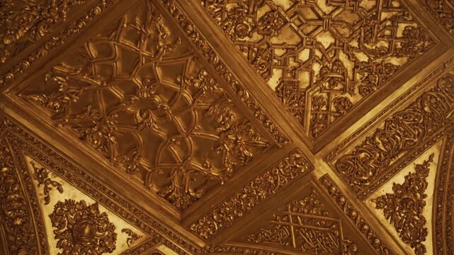 Richly decorated golden ceiling with elegant baroque motifs and lighting