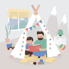 Dad reading for kid. Family sitting in wigwam playhouse with book. Friendly family reading books together at home. Fatherhood, father spending time with son. © Marina